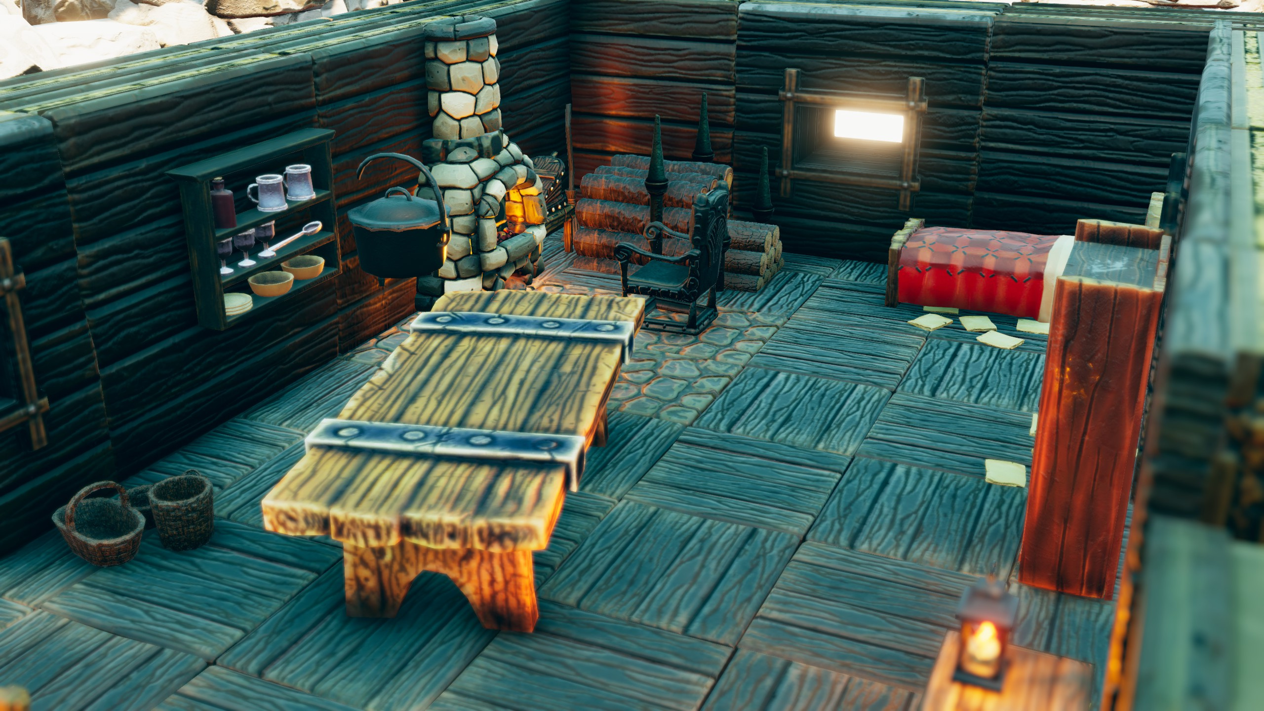 Close view of the cabin's hearth, cooking pot, shelves and table