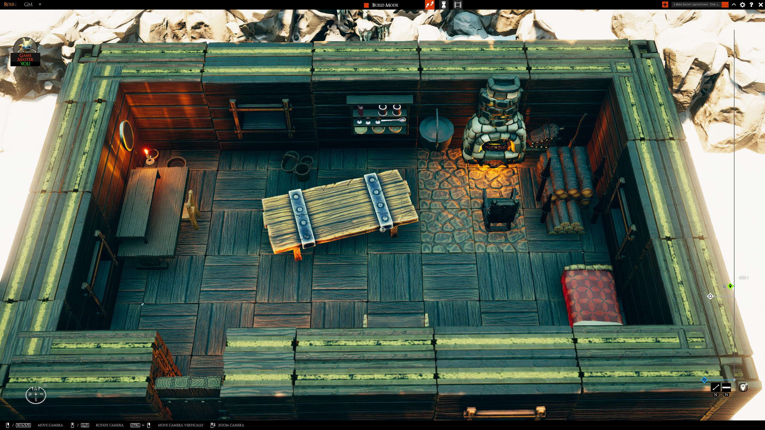 Looking down into the cabin's interior with a hearth, table and bed